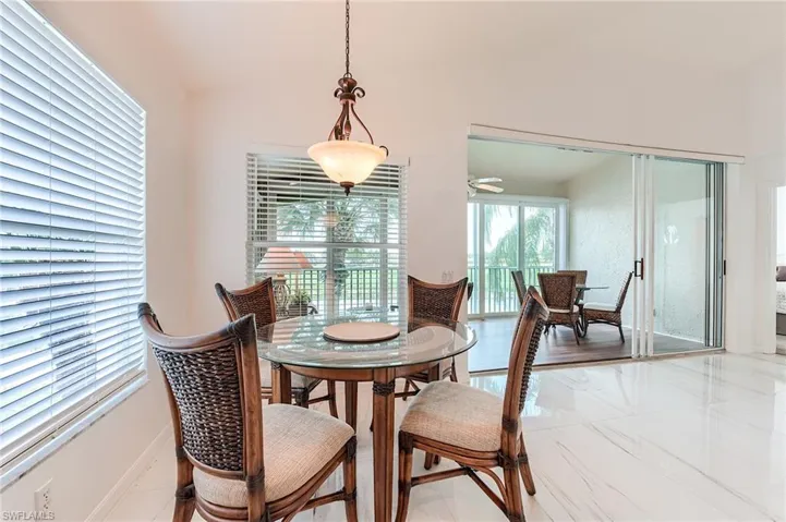 Dining room with a ceiling fan and baseboards