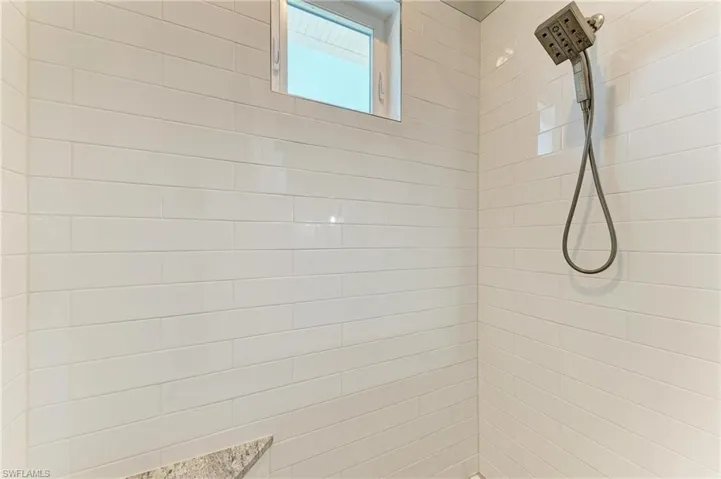 Room details featuring a tile shower
