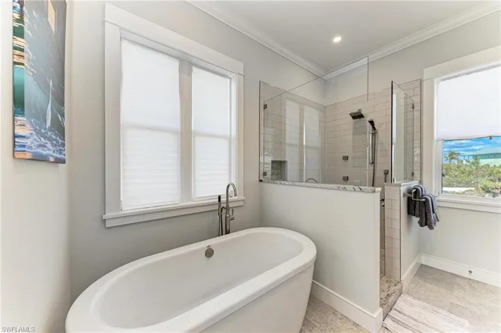 Bathroom with plus walk in shower and ornamental molding