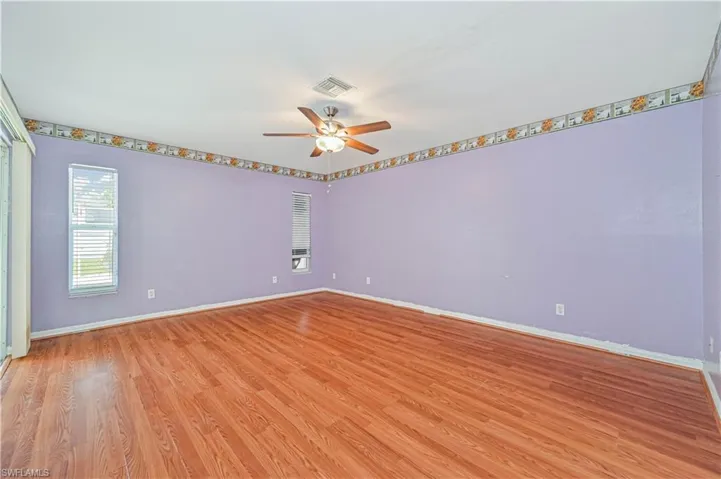 Spare room with ceiling fan and light wood-type flooring