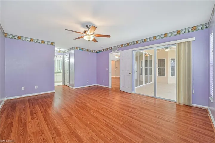 Empty room with ceiling fan and wood-style floors