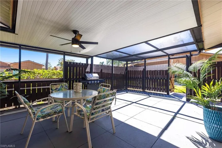 View of patio with area great for grilling, and outdoor dining area, and a lanai