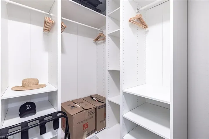 View of spacious closet with custom organizer.