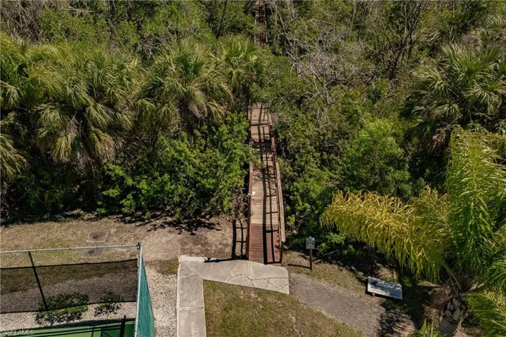 View of home's community with fence