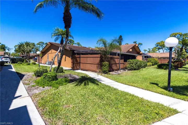 View of front of property featuring a front yard and fence