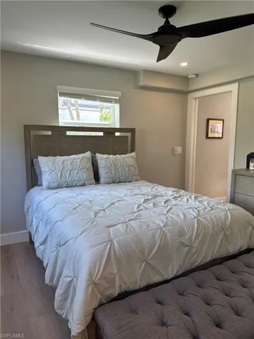 Bedroom featuring a ceiling fan, baseboards, and wood finished floors