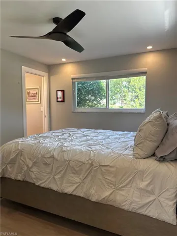 Bedroom featuring a ceiling fan, wood finished floors, and recessed lighting