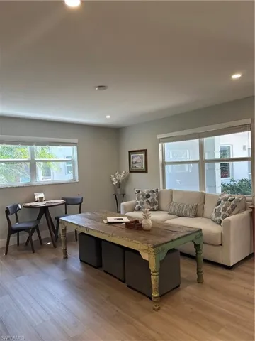 Living area with recessed lighting and light wood-type flooring