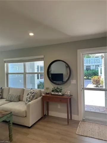 Living area with baseboards, light wood-type flooring, and recessed lighting