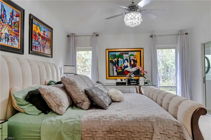 Bedroom with ceiling fan and vaulted ceiling