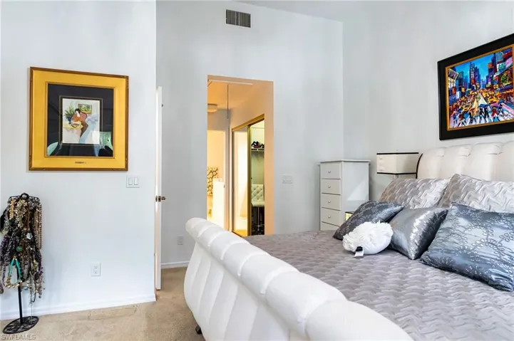 Carpeted bedroom with walk in closet