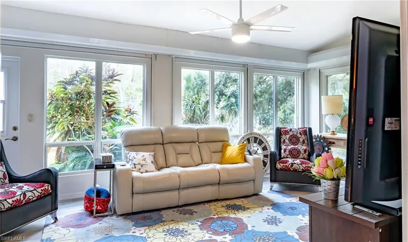 Sunroom / solarium featuring plenty of natural light and ceiling fan