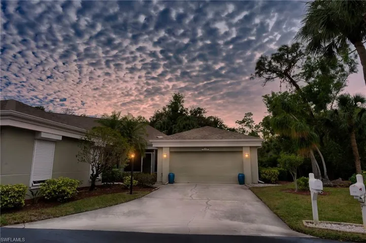 Single story home with a garage and a yard