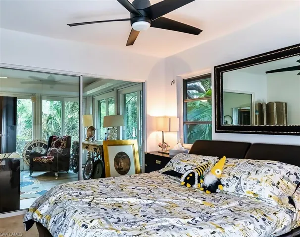 Bedroom with ceiling fan sliding door to the Florida room