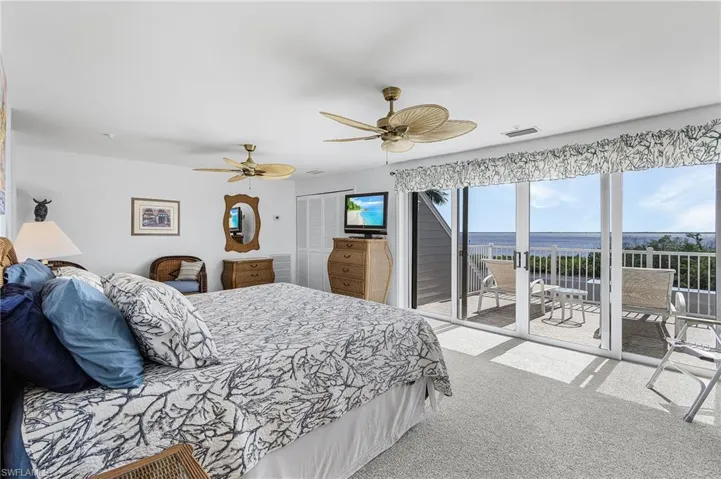 Bedroom featuring carpet flooring, a closet, access to exterior, and ceiling fan