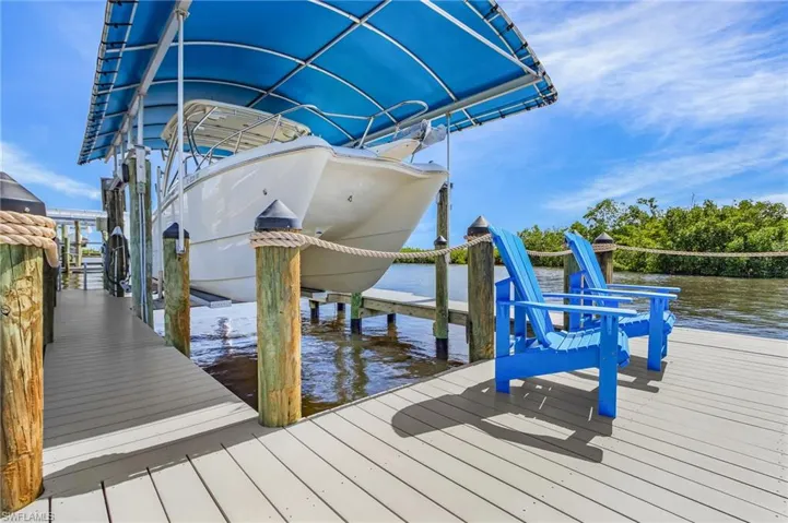 Dock with boat lift and a water view
