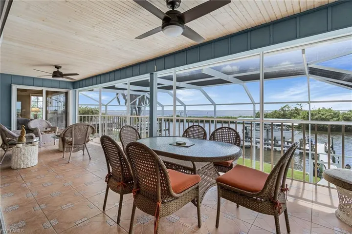 Sunroom / solarium featuring a water view
