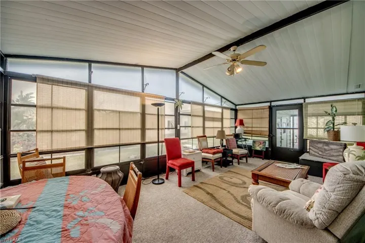 Sunroom featuring ceiling fan, beam ceiling, and outdoor lounge area