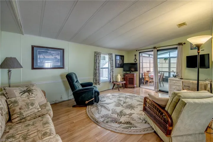 Living area with wood finished floors and lofted ceiling