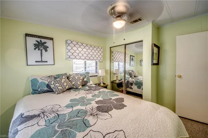 Bedroom featuring ceiling fan, carpet flooring, a closet, and crown molding