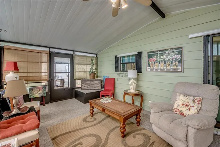 Sunroom / solarium with a ceiling fan, an outdoor hangout area, and beam ceiling