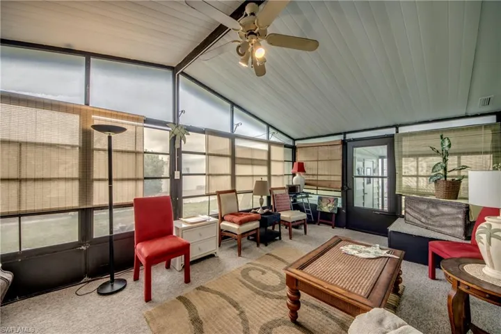 Sunroom with ceiling fan, lofted ceiling, and an outdoor lounge area