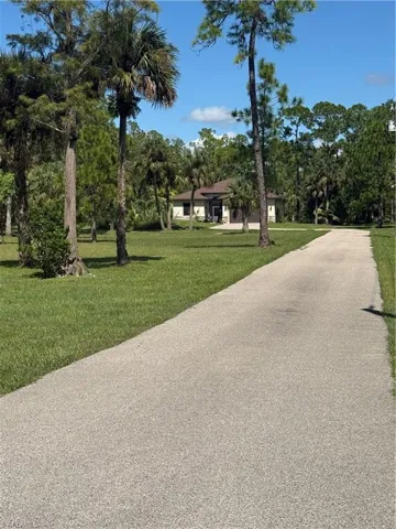 View of home's community with a yard