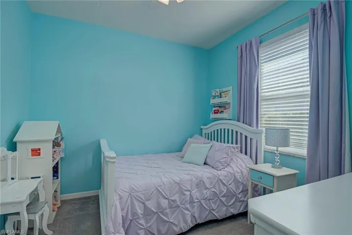 Bedroom featuring dark colored carpet and ceiling fan