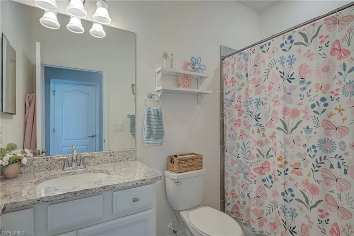 Full bath featuring a shower with curtain and vanity