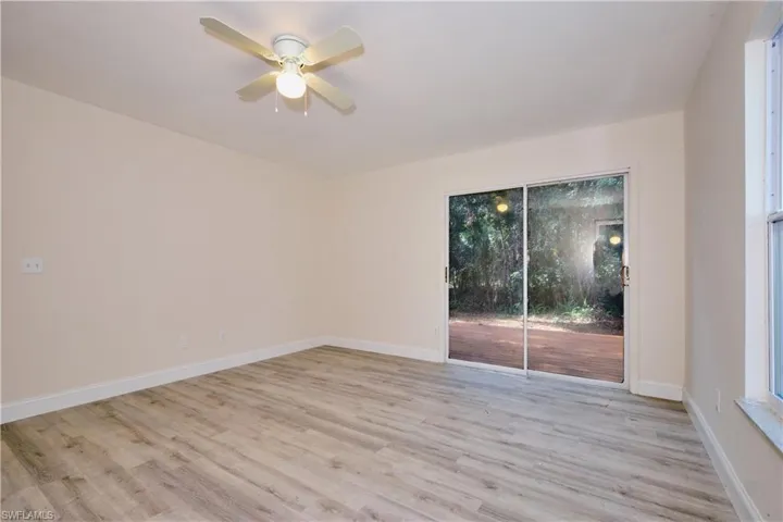 Empty room featuring light wood-type flooring and a ceiling fan