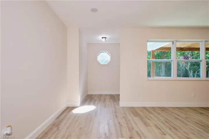 Empty room featuring baseboards and light wood-style floors