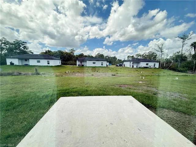 View of grassy yard with a patio
