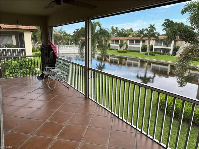 Balcony featuring ceiling fan and a water view