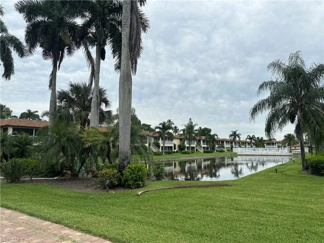 View of home's community featuring a lawn and a water view