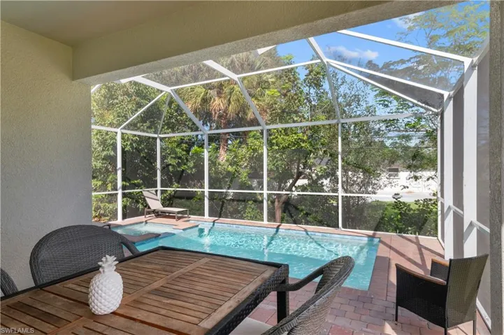 Swimming pool featuring a patio and a lanai