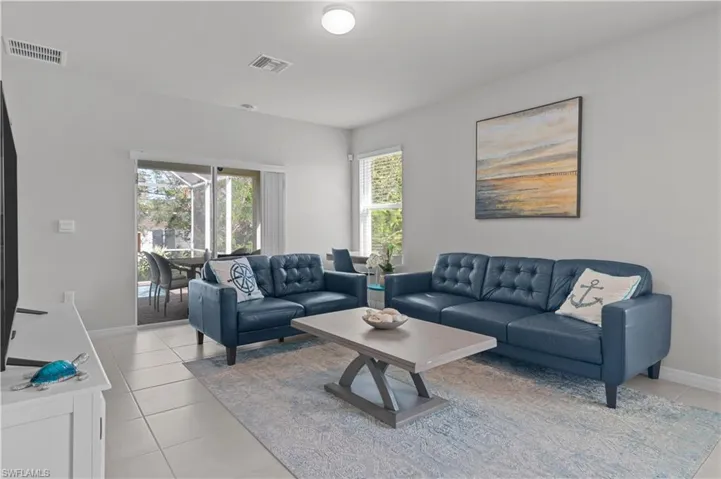 Living area featuring baseboards and light tile patterned floors