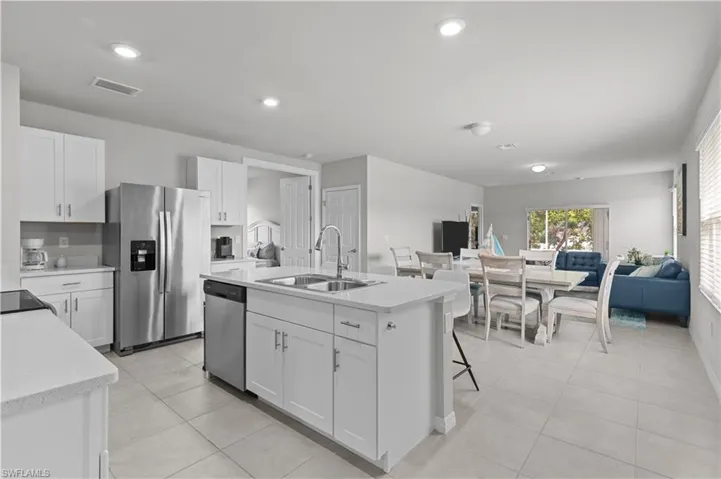 Kitchen featuring appliances with stainless steel finishes, light tile patterned floors, white cabinetry, and recessed lighting
