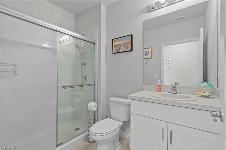 Full bath with vanity and a shower stall