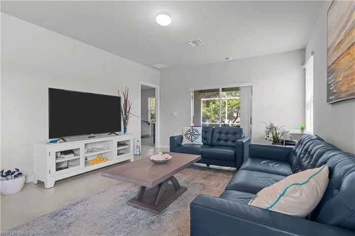 Living room featuring tile patterned flooring and baseboards