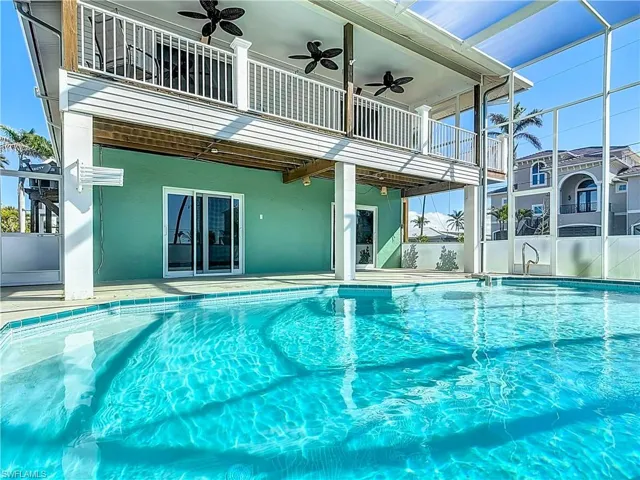 Pool with a ceiling fan and a patio