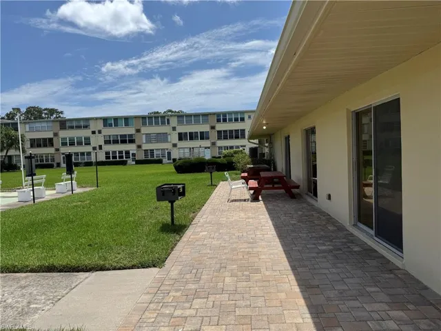 Surrounding community with a yard and BBQ area