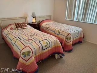 Guest Bedroom with carpet floors and baseboards