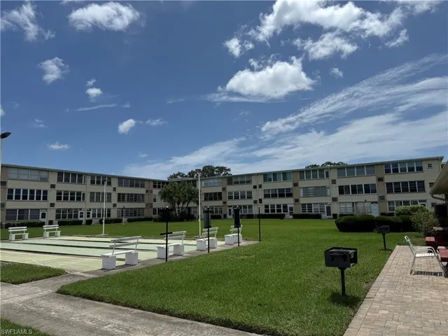 Surrounding community featuring shuffleboard and a yard