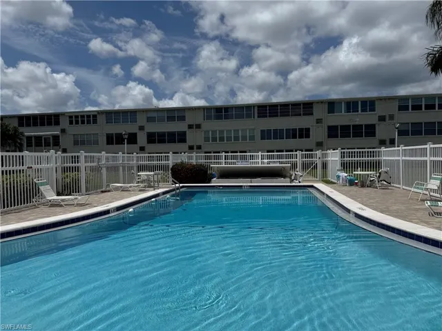 Community pool with a patio