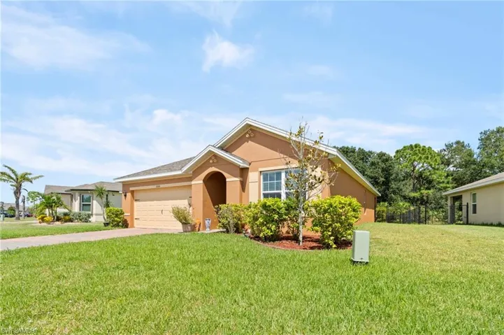 Single story home featuring concrete driveway, stucco siding, and an attached garage