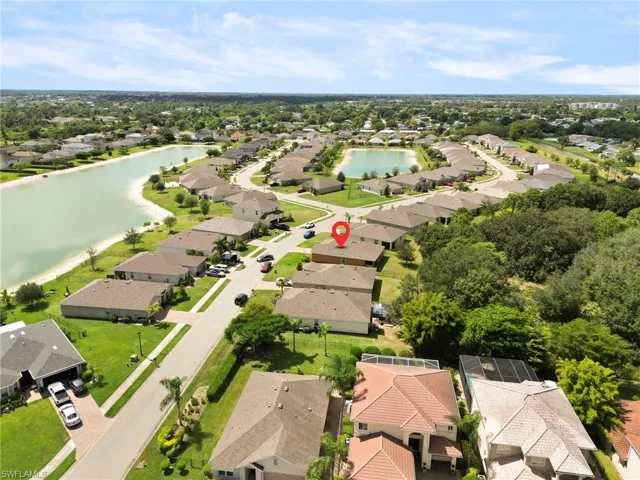 Aerial perspective of suburban area featuring a nearby body of water