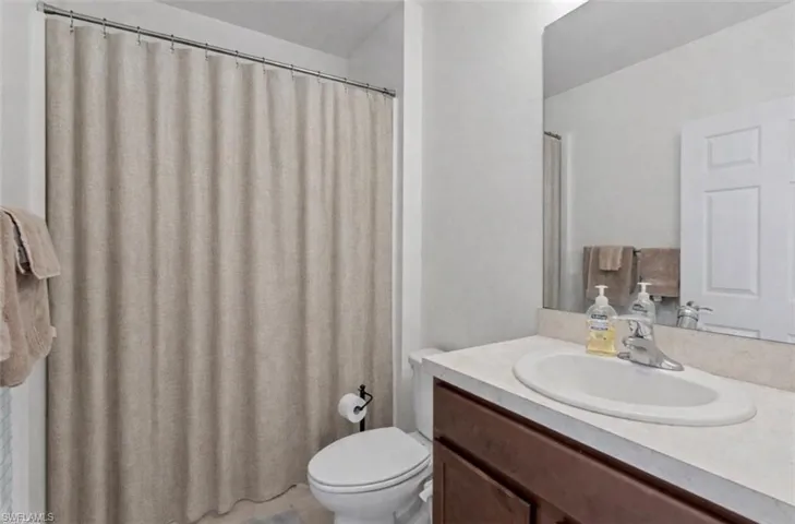 Bathroom with vanity and a shower with curtain