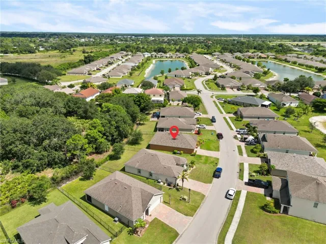 Aerial view of residential area featuring a nearby body of water