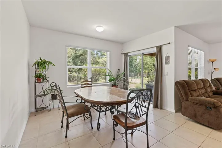 Dining space with plenty of natural light and light tile patterned floors