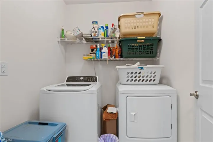 Washroom with washer and clothes dryer
